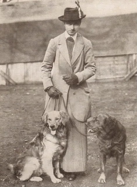 Winifred Charlesworth standing with two early Golden Retrievers